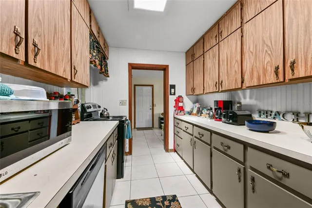 a kitchen with a sink cabinets and appliances
