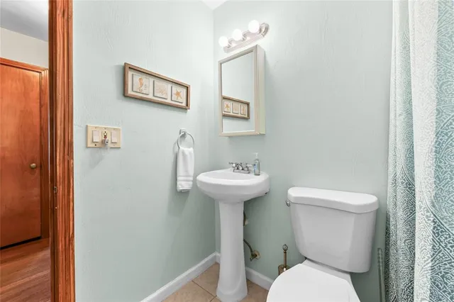 a white toilet sitting next to a bathroom sink