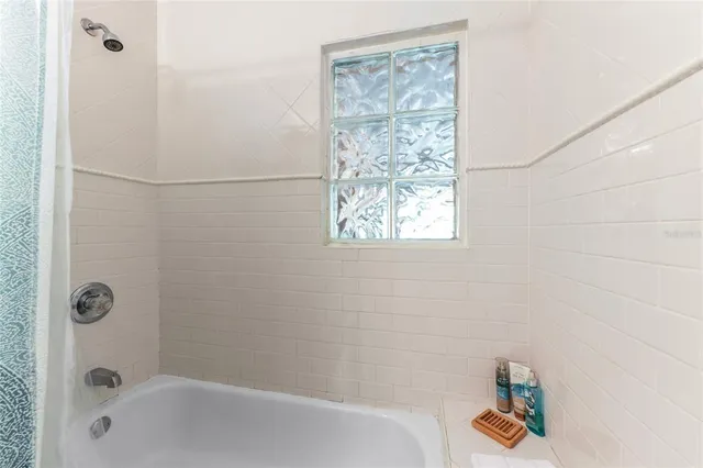 a bathroom with a bathtub and shower