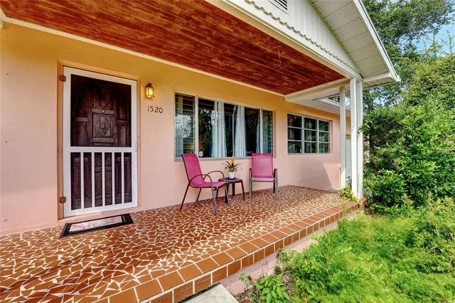 a view of a house with backyard and sitting area