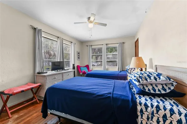 a bedroom with a bed and wooden floor