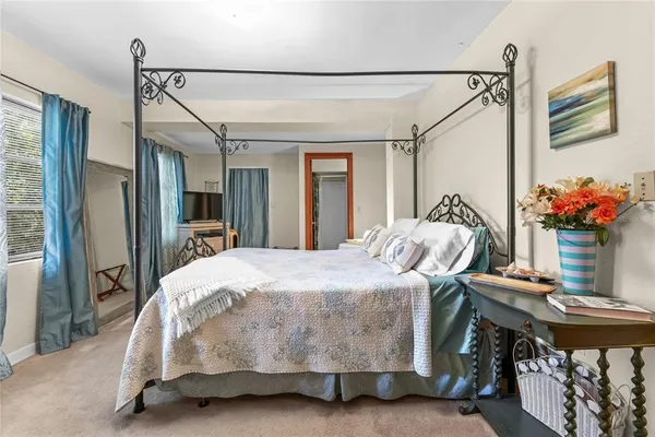 a bedroom with a bed and a table