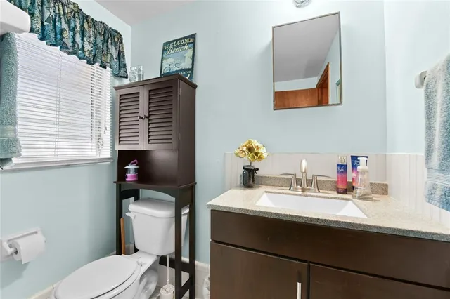 a bathroom with a sink toilet and mirror