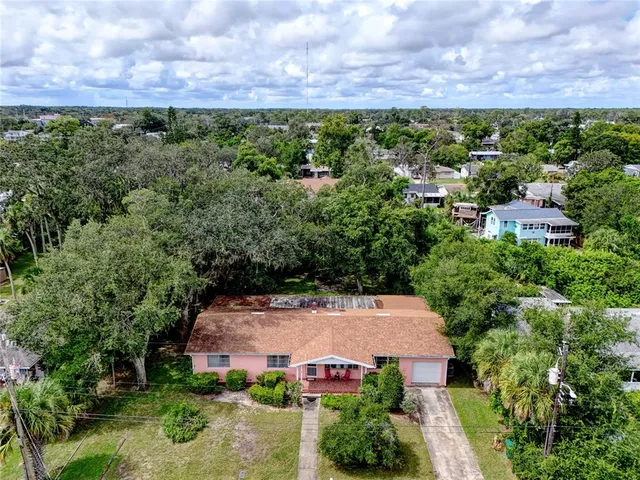 an aerial view of a house with a yard