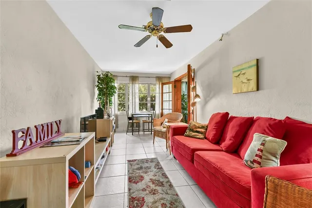 a living room with furniture ceiling fan and a rug