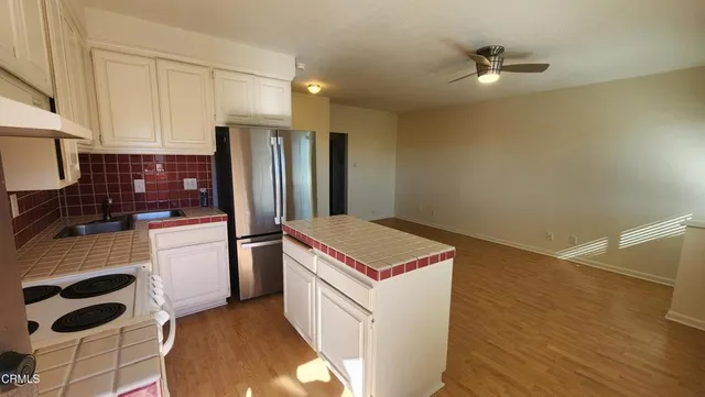 a kitchen with a refrigerator and cabinets