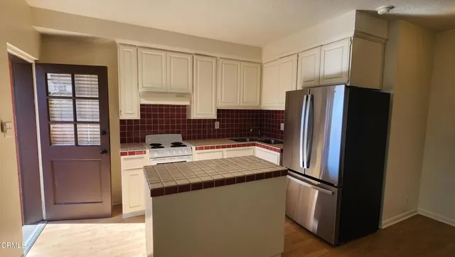 a kitchen with a refrigerator sink and stove