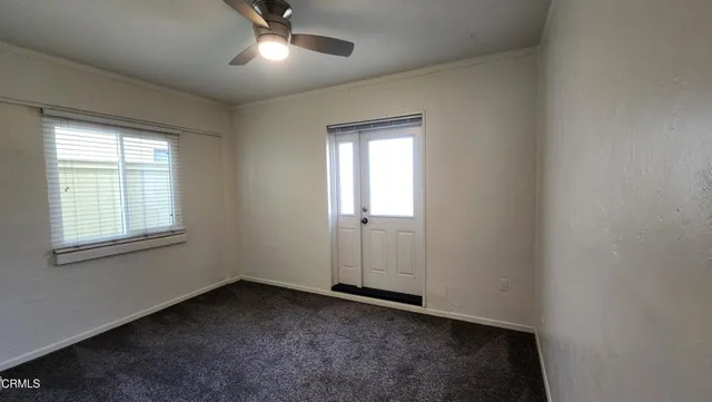 an empty room with a empty space and windows