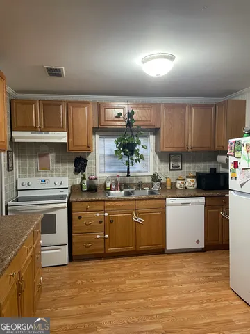 a kitchen with stainless steel appliances granite countertop a sink and cabinets