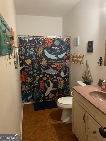 a bathroom with a toilet sink and mirror