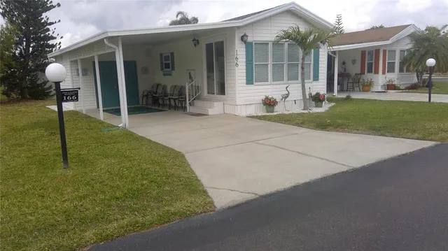 a view of a house with backyard and porch