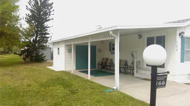 a view of house with backyard space and porch