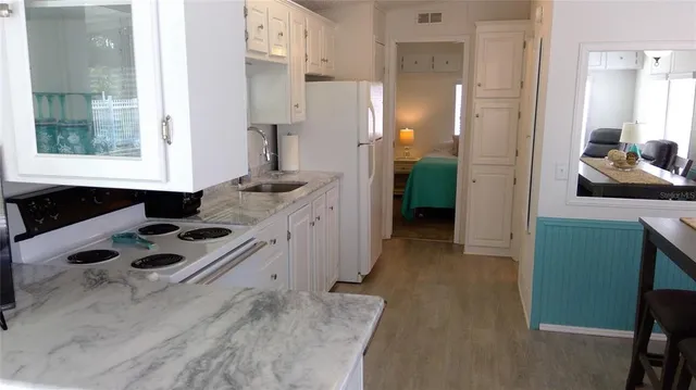 a kitchen with a sink stove and refrigerator