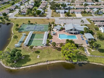 an aerial view of a house with a yard swimming pool and outdoor seating