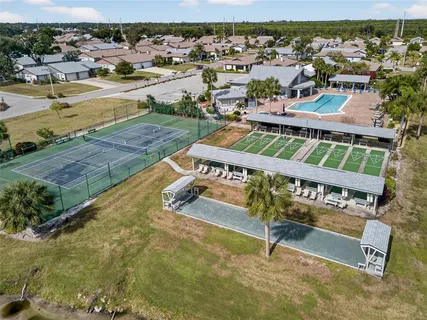 a view of a swimming pool with lawn chairs