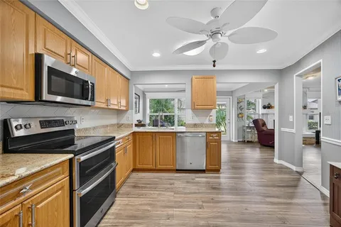 a kitchen with a stove a sink and a microwave
