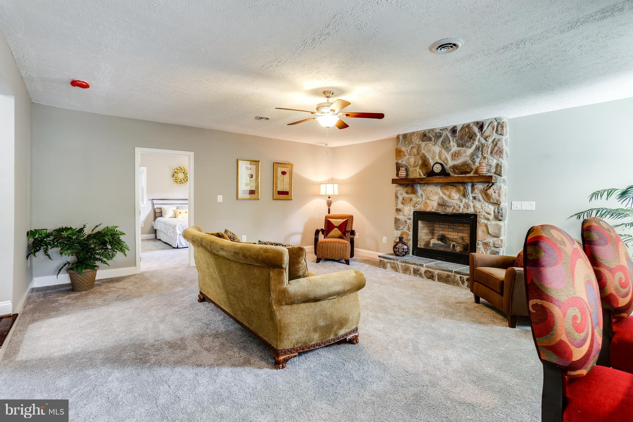 1700 Quantico Road Edgewater, MD 21037 - Photo 8 of 25 a living room with furniture and a fireplace
