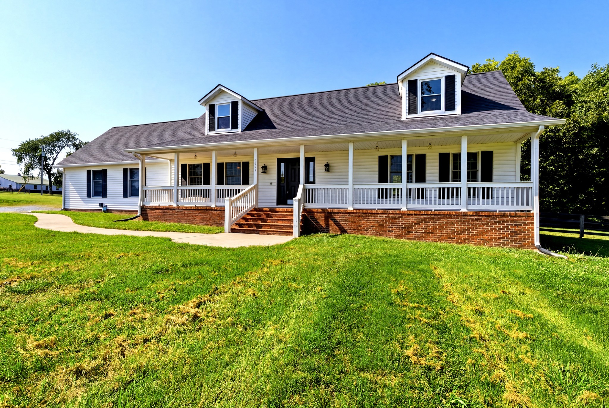 3434 Kinneys Road Cedar Hill, TN 37032 - Photo 4 of 90 a front view of a house with garden and swimming pool