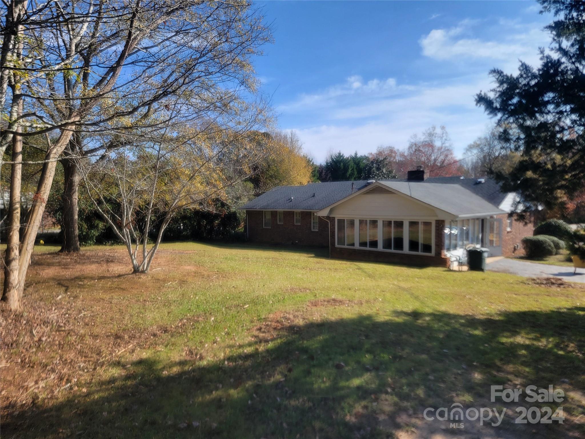 115 Hidden Hill Road Union, SC 29379 - Photo 9 of 35 a blue swimming pool is in front of a brick house