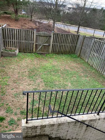 a view of a backyard with wooden fence