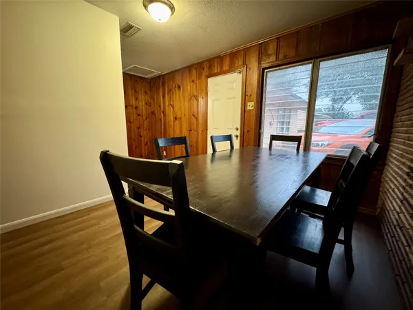 a view of a dining room with furniture and window