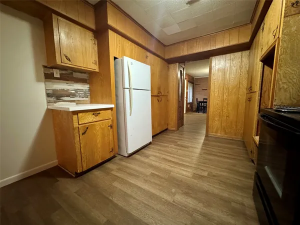 a kitchen with stainless steel appliances granite countertop a refrigerator a stove and a microwave oven with wooden floor