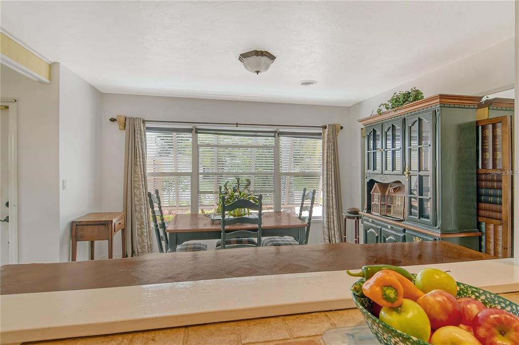 449 Redwood Road Venice, FL 34293 - Photo 13 of 40 a living room with furniture and a floor to ceiling window