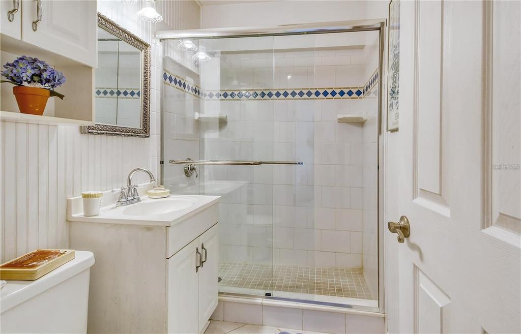 449 Redwood Road Venice, FL 34293 - Photo 16 of 40 a bathroom with a sink a mirror and a shower