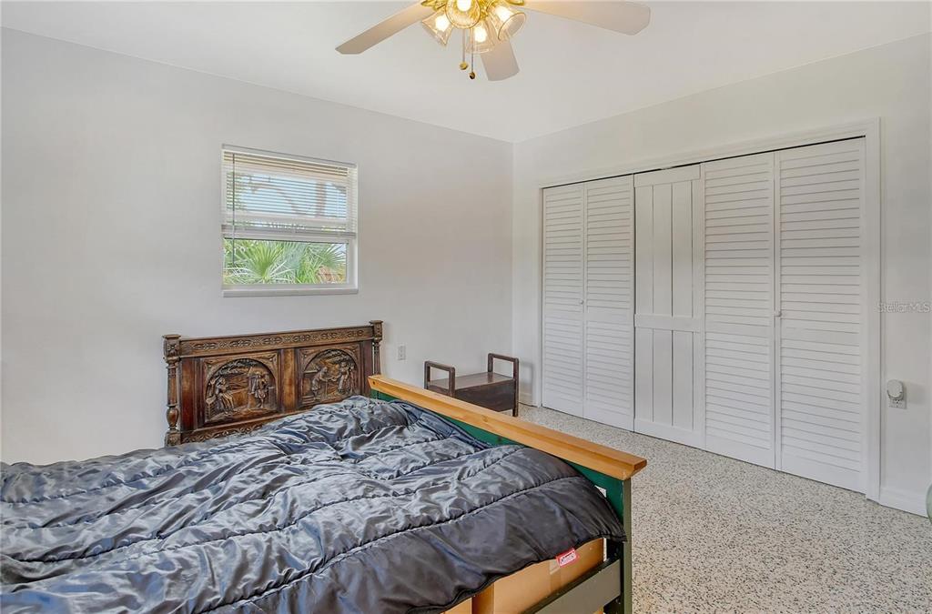 449 Redwood Road Venice, FL 34293 - Photo 18 of 40 a bedroom with a bed and a chandelier