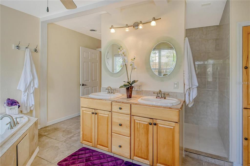 449 Redwood Road Venice, FL 34293 - Photo 21 of 40 a en suite bathroom with a double vanity sink and a mirror