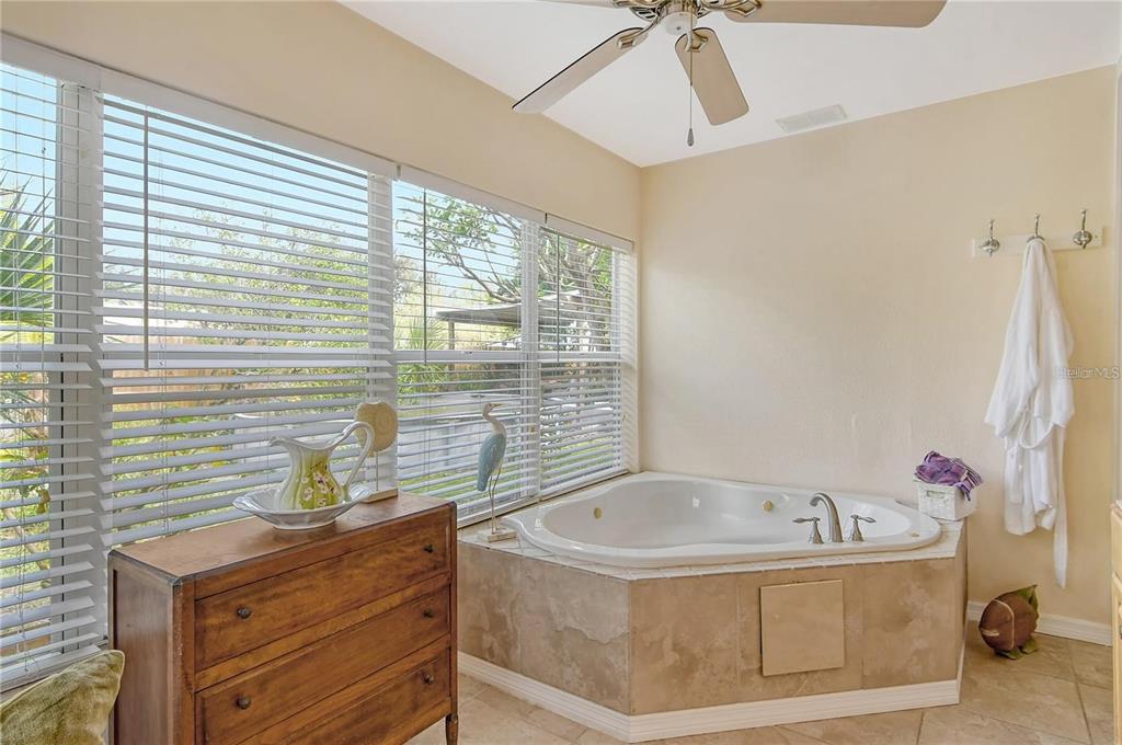 449 Redwood Road Venice, FL 34293 - Photo 22 of 40 a bathroom with a tub sink and mirror
