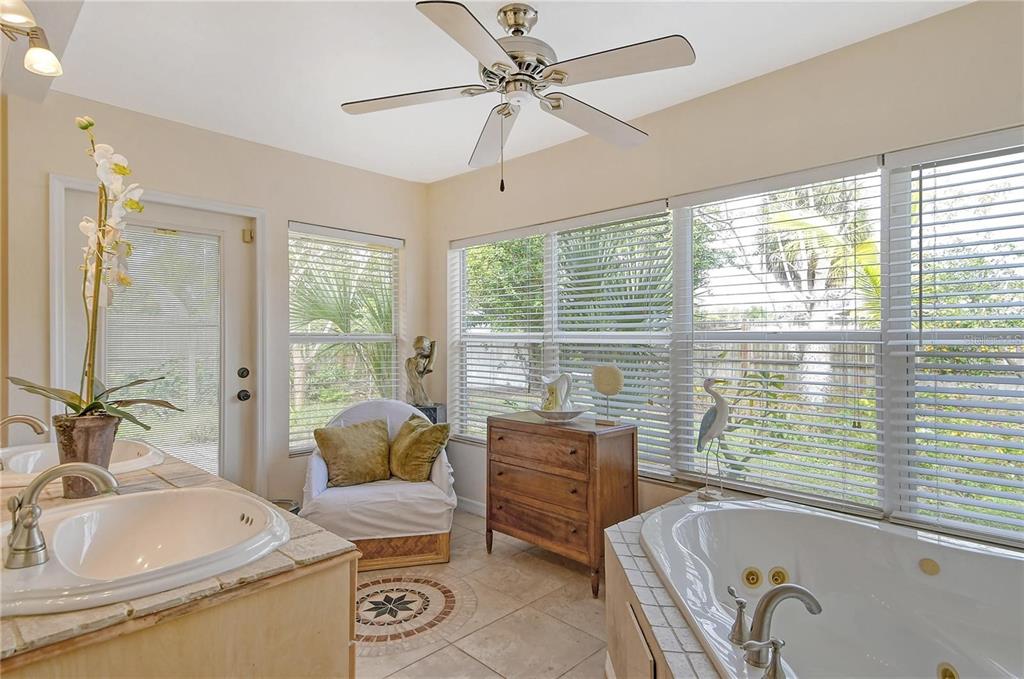 449 Redwood Road Venice, FL 34293 - Photo 23 of 40 a bathroom with a tub sink and mirror