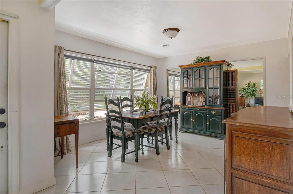 449 Redwood Road Venice, FL 34293 - Photo 9 of 40 a view of a dining room with furniture and window