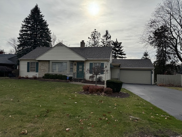 3307 North View Road Rockford, IL 61107 - Photo 1 of 19 a front view of a house with a garden and yard