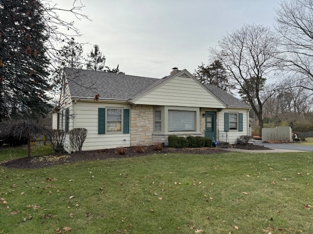 3307 North View Road Rockford, IL 61107 - Photo 2 of 19 a front view of a house with a garden and trees