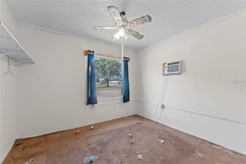 a view of a room with a chandelier fan and a closet