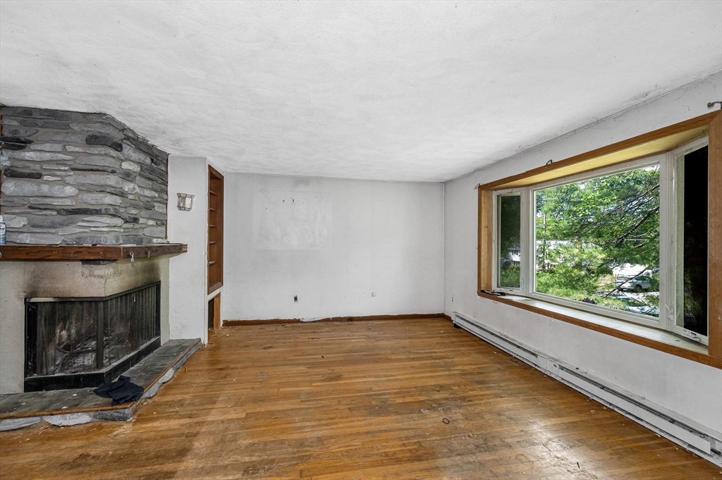 19 Porter Street Billerica, MA 01821 - Photo 12 of 23 a view of empty room with wooden floor and fireplace