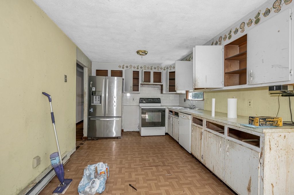 19 Porter Street Billerica, MA 01821 - Photo 14 of 23 a large kitchen with stainless steel appliances a stove a sink dishwasher a refrigerator and cabinets