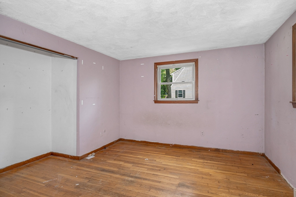 19 Porter Street Billerica, MA 01821 - Photo 17 of 23 a view of an empty room with wooden floor and a window