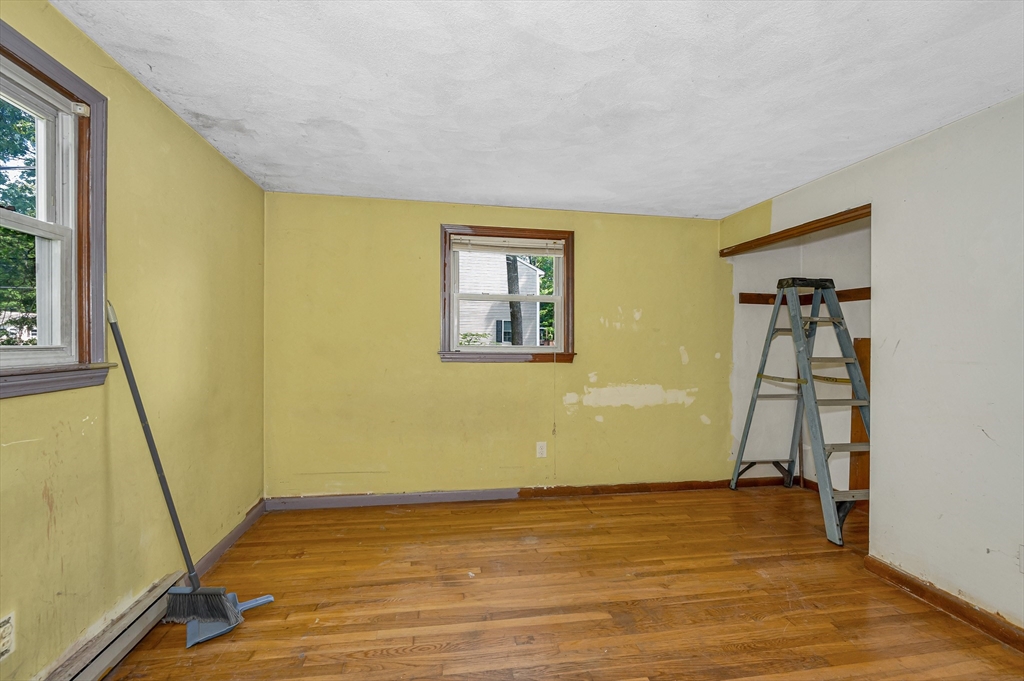 19 Porter Street Billerica, MA 01821 - Photo 18 of 23 a view of an empty room with wooden floor and a window
