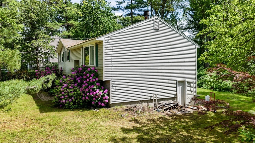 19 Porter Street Billerica, MA 01821 - Photo 8 of 23 a view of a house with a yard and potted plants