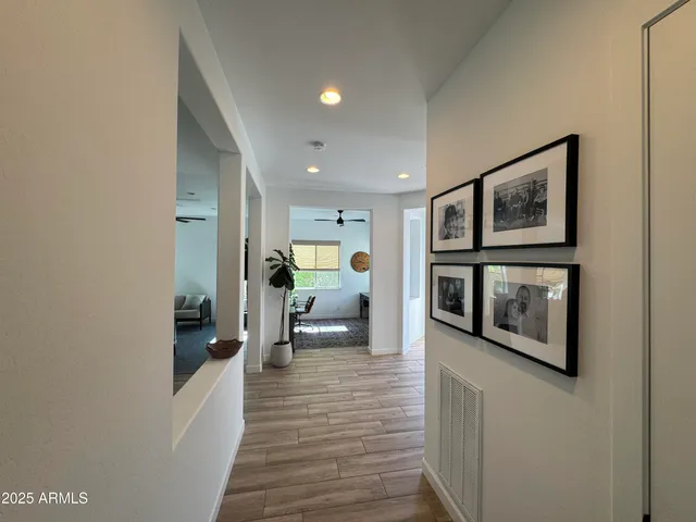 a hallway with wooden floor and furniture