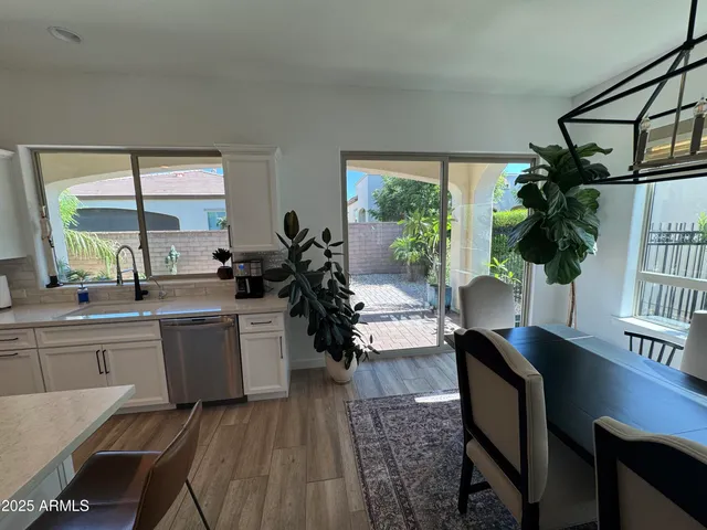 a kitchen with sink and view of living room