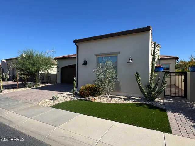 a view of a house with backyard and a tree