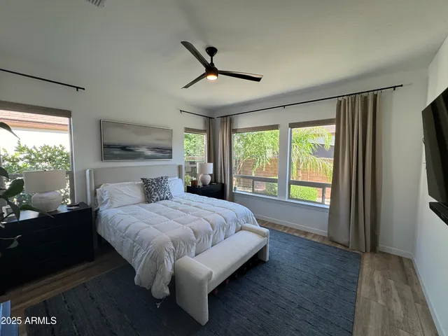 a bedroom with a large bed and a large window