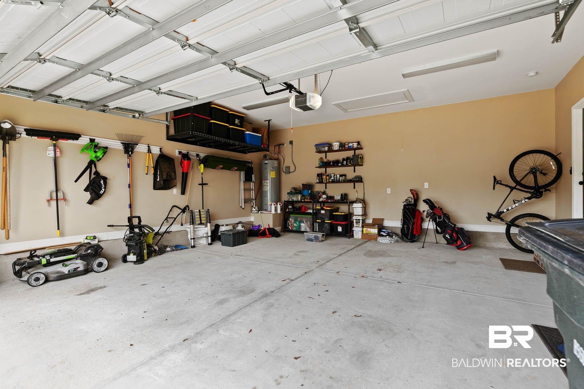 19740 Bunker Loop Fairhope, AL 36532 - Photo 29 of 33 Garage with electric water heater and a garage door opener