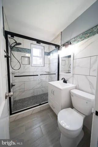 a bathroom with a toilet sink and shower