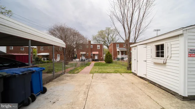 a view of a street with a building and a big yard