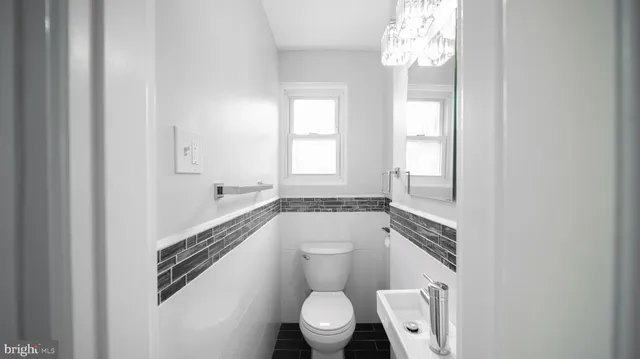 a bathroom with a toilet a sink and a window