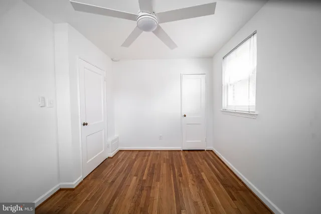 wooden floor in an empty room with a window